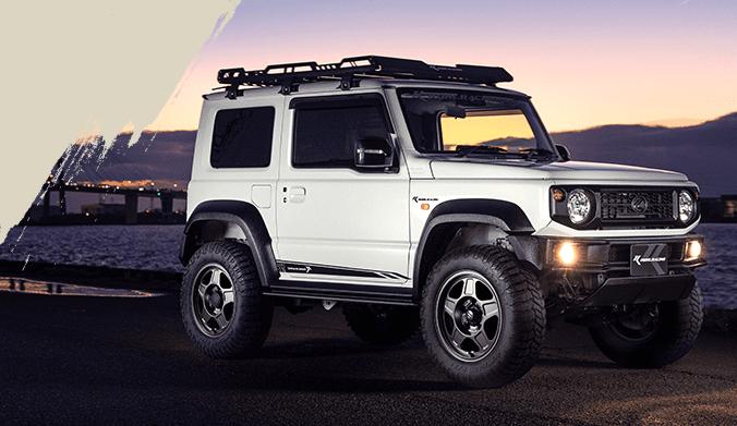 Suzuki Jimny Sierra with OFFLESSER TS-5 wheels in an urban evening setting